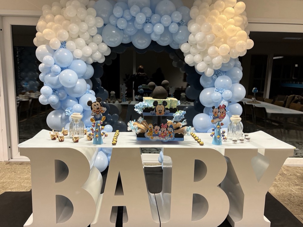 Grosse BABY-Buchstaben vor einem Ballonbogen in Hellblau und Weiss